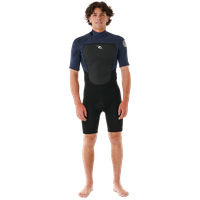 **Bereite Dich mit dem Omega 2/2 Shortyanzug von Ripcurl auf Deine nächste Surfsession vor.** Dieser Neoprenanzug hat einen Reißverschluss im Rücken und besteht zu 80% aus Neopren und zu 20% aus Polyamid. Er enthält E5- und E3-Neopren