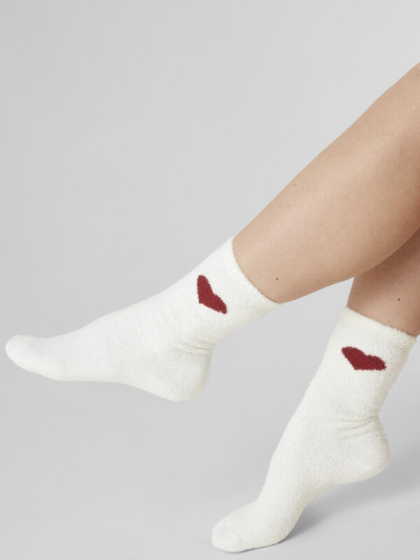 Wohlige Gemütlichkeit für Ihre Füße: Die Blue Check Socken in Creme-Bunt sind perfekt für kalte Nächte und gemütliche Tage. Die praktische Doppelpackung bietet ein Paar im Check Muster und ein Paar Uni mit Herz. Diese kuschelig weichen Socken eignen sich hervorragend als Schlafsocken und passen dank Einheitsgröße zu jeder Schuhgröße. Eine perfekte Ergänzung zur Blue Check Nachtwäsche.