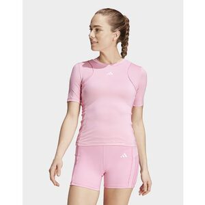 Mit diesem adidas Trainingsshirt startest du voller Energie in dein nächstes Workout. Es ist aus stretchigem Jersey und garantiert dir optimale Bewegungsfreiheit beim Barre- oder HIIT-Workout. Außerdem schmiegt sich der eng anliegende Schnitt perfekt an deinen Körper an und setzt deine Figur perfekt in Szene. Die farbige Paspelierung und die 3-Streifen an den Seiten sorgen dabei für einen sportlichen Look.  Dieses Produkt ist mit mindestens 70 % recycelten Materialien hergestellt. Die Wiederverwendung bereits vorhandener Materialien hilft uns dabei